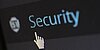 Cursor in Gestalt eine ausgestreckten Zeigefingers zeigt auf einen Button mit dem Schriftzug "Security".auf